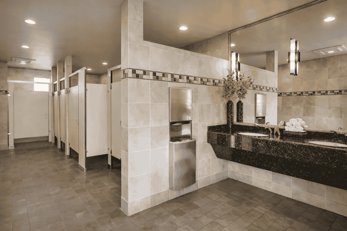 Modern and clean bathroom facilities at Oak Creek RV Resort, featuring private stalls, stylish sinks, and ample lighting for a comfortable experience.