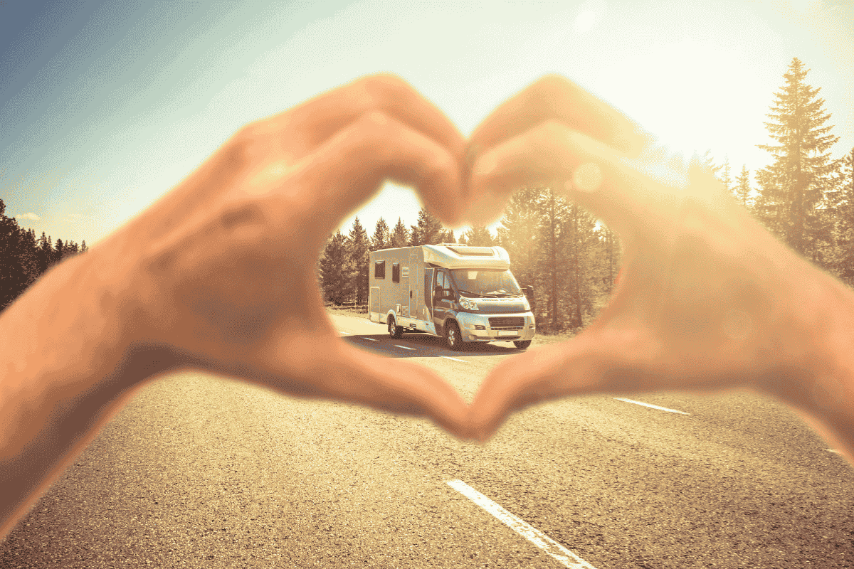 Hands forming a heart over a motorhome